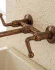 Rustic Aged Copper Wall Faucet with Crossbar Lever Handles